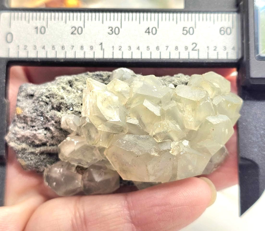 Calcite crystal cluster with pyrite on a sparkling dark matrix