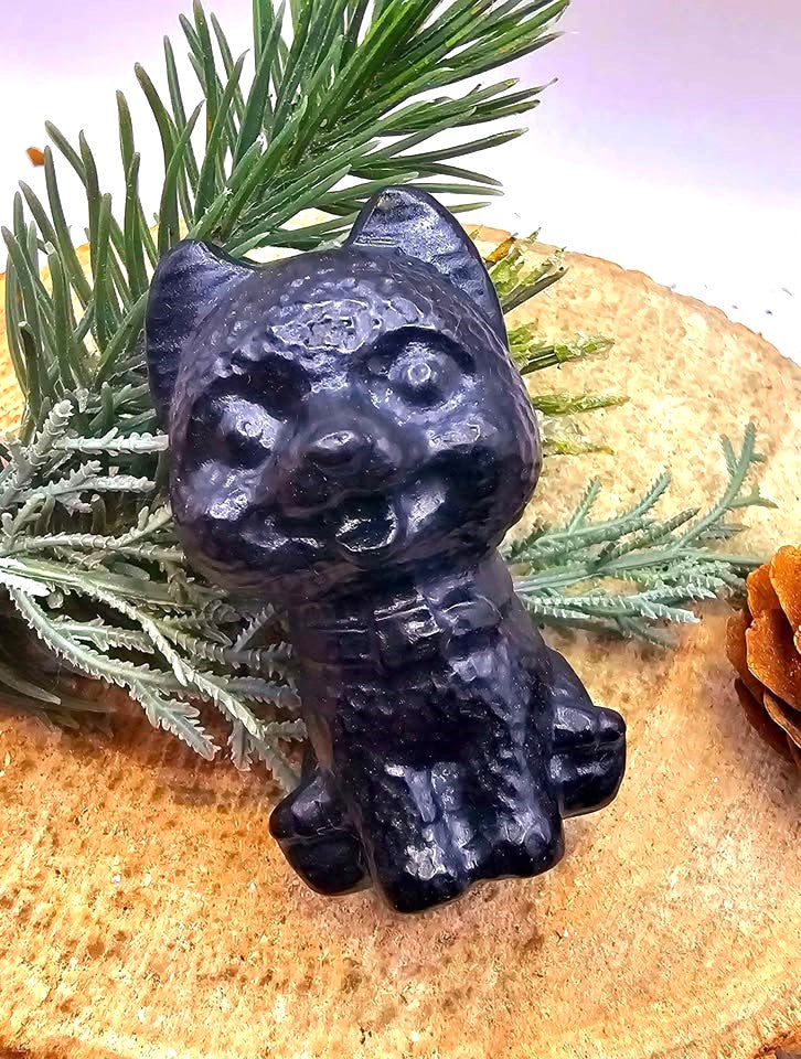 Black obsidian carved cheerful dog decor figure close-up — My Aura Gemstones