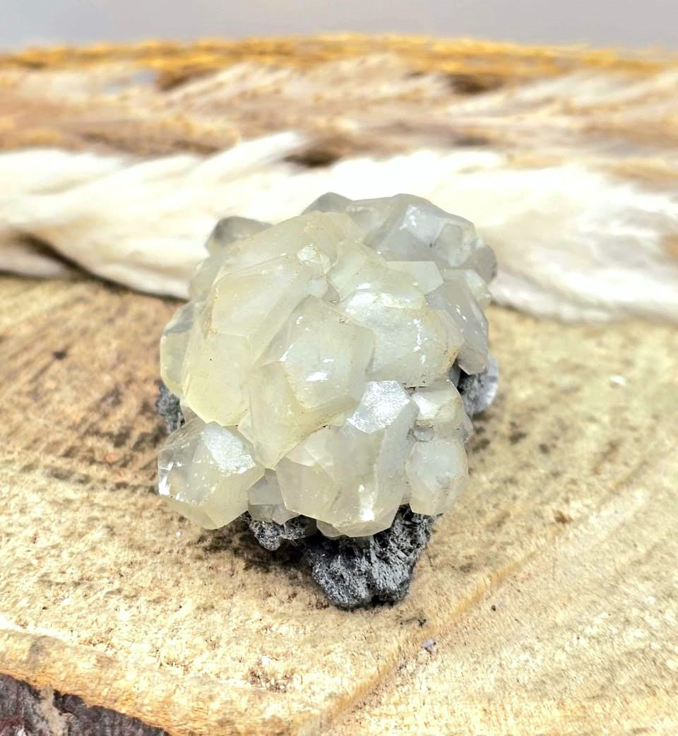 Calcite crystal cluster with pyrite on a sparkling dark matrix 