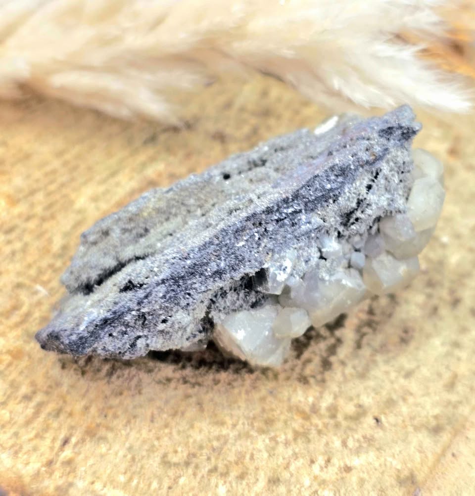 Calcite crystal cluster with pyrite on a sparkling dark matrix 