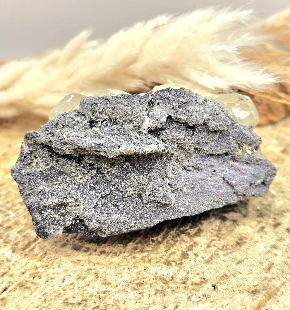 Calcite crystal cluster with pyrite on a sparkling dark matrix 
