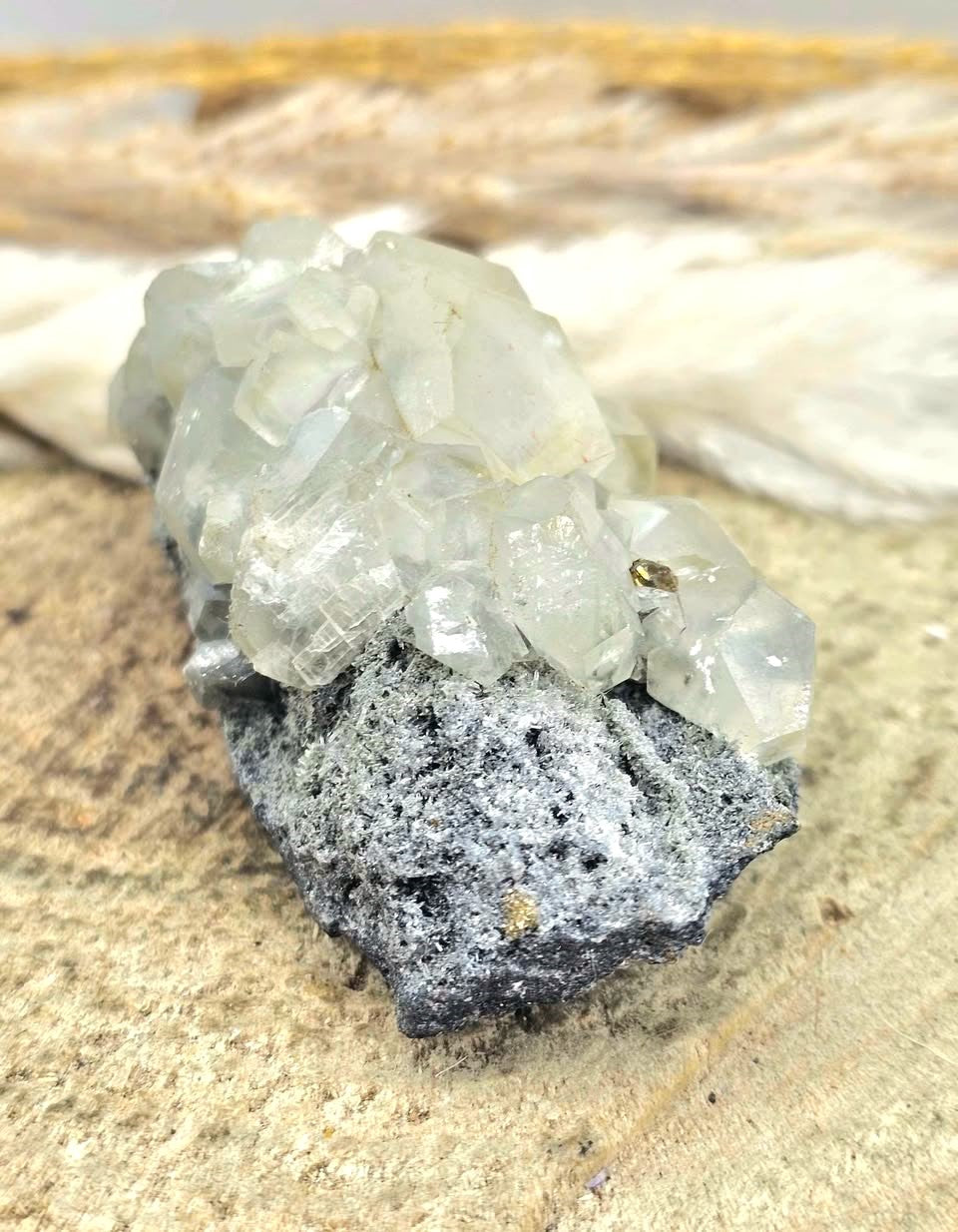 Calcite crystal cluster with pyrite on a sparkling dark matrix 