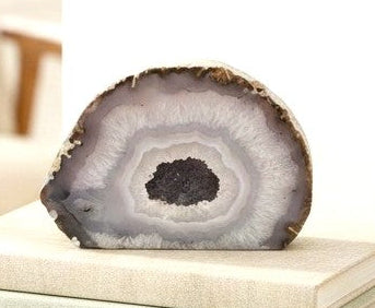 Natural druzy geode crystal with sparkling cavern displayed on white background, polished slice showing layered mineral bands-My Aura Gemstones