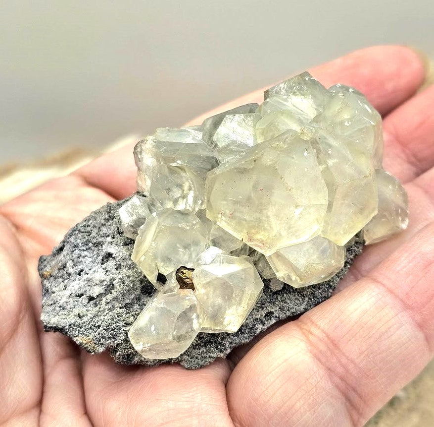 Calcite crystal cluster with pyrite on a sparkling dark matrix 