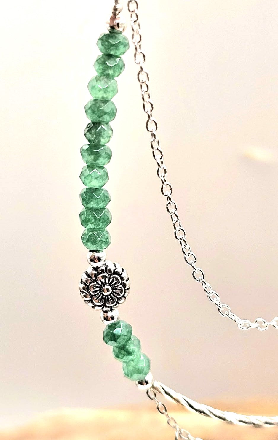 “Handmade strawberry quartz necklace with faceted flashy beads and multi‑chain hanging drop design on silver accents