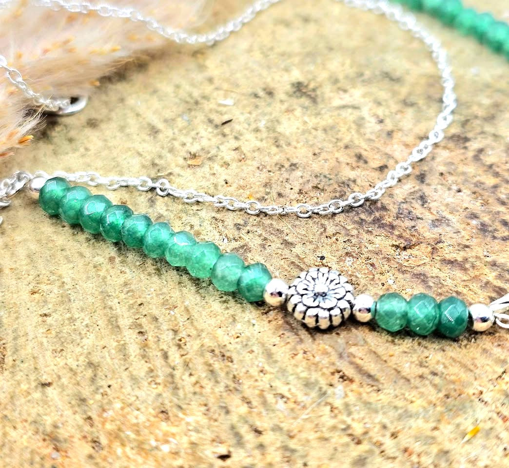 “Handmade strawberry quartz necklace with faceted flashy beads and multi‑chain hanging drop design on silver accents