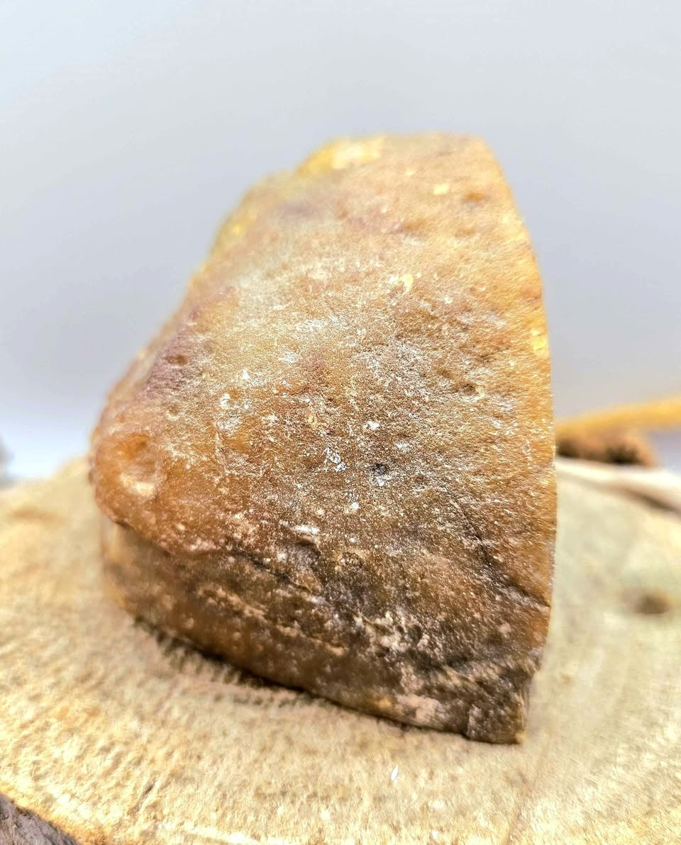 Natural quartz geode specimen with tan rough outer crust and sparkling white druzy crystal interior, standing upright.