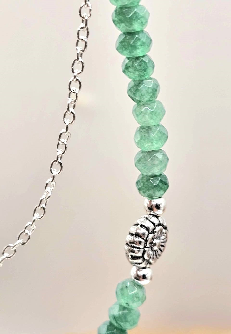 “Handmade strawberry quartz necklace with faceted flashy beads and multi‑chain hanging drop design on silver accents