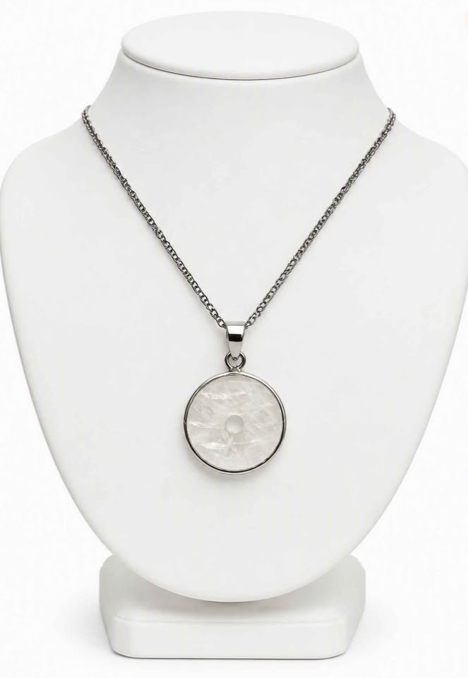 Natural clear crystal donut pendant with metal wrap, Ping An Kou peace amulet necklace, 0.7 inch- on jewelry stand-My Aura Gemstones
