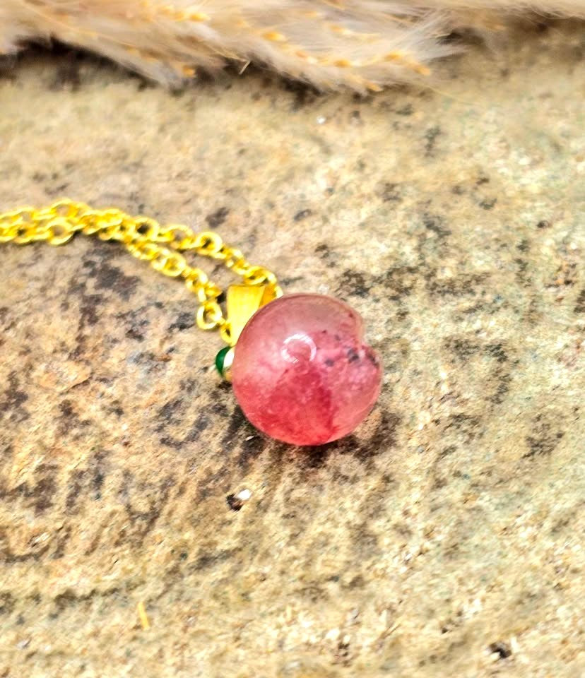 Mini peach pendant carved from natural strawberry quartz with metal leaf and matching gold chain, 18–20 inches-My Aura Gemstones