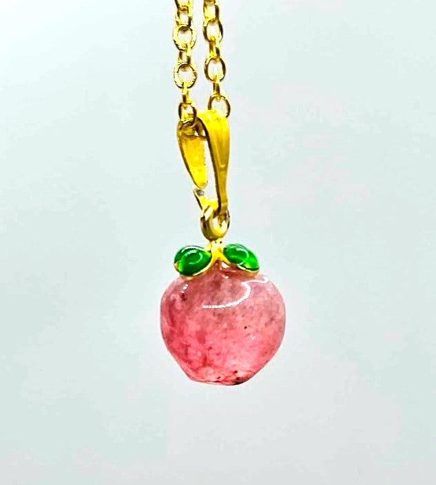 Mini peach pendant carved from natural strawberry quartz with metal leaf and matching gold chain, 18–20 inches-My Aura Gemstones