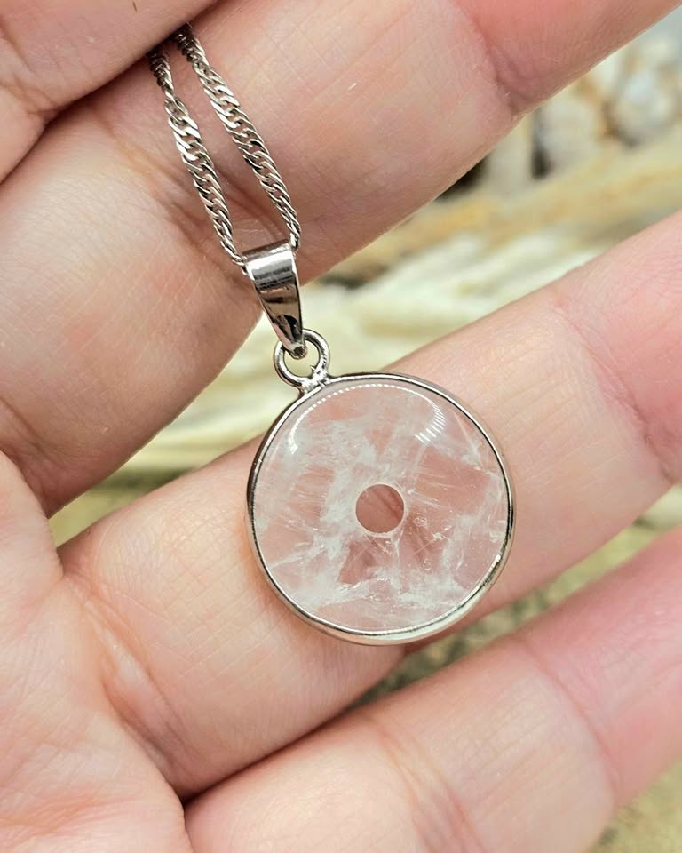 Natural clear crystal donut pendant with metal wrap, Ping An Kou peace amulet necklace, display on hand,  0.7 inch-My Aura Gemstones