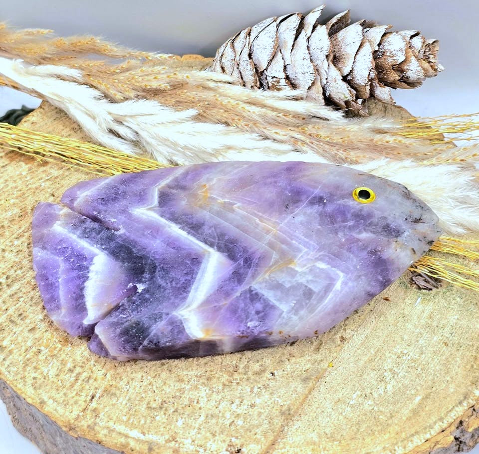 Hand‑carved Dream Amethyst fish figurine with chevron pattern and purple quartz, 4.1 inch crystal carving, flat view-My Aura Gemstones