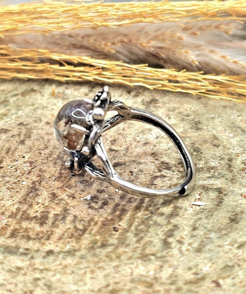 Garden quartz ring with high‑clarity crystal and green‑brown inclusions, floral wood‑branch band with butterfly, adjustable size, side view-My Aura Gemstones