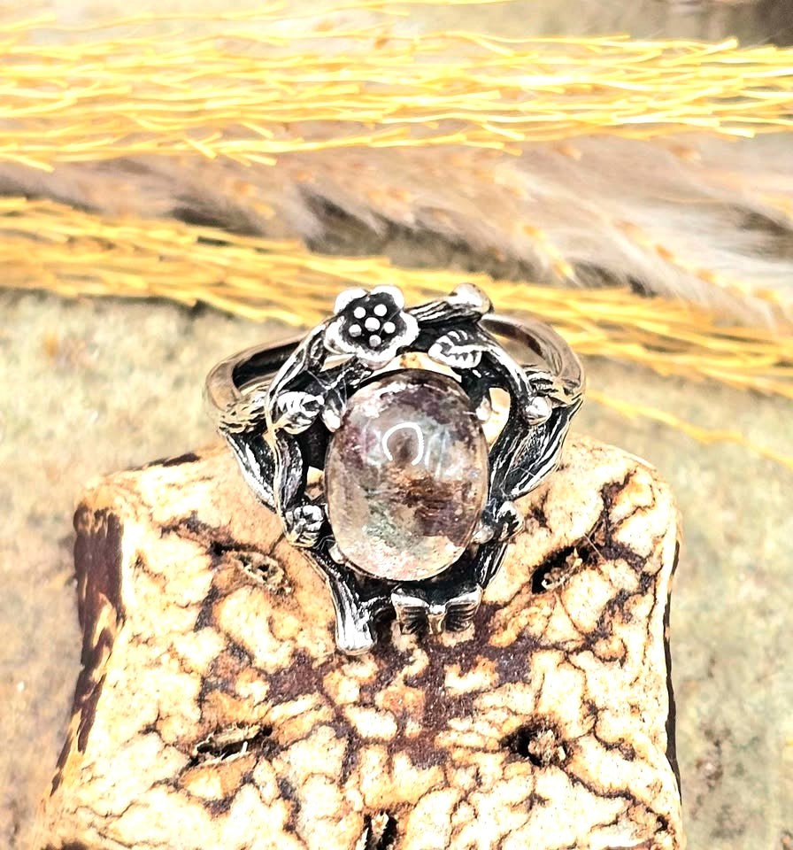 Garden quartz ring with high‑clarity crystal and green‑brown inclusions, floral wood‑branch band with butterfly, adjustable size, top view-My Aura Gemstones