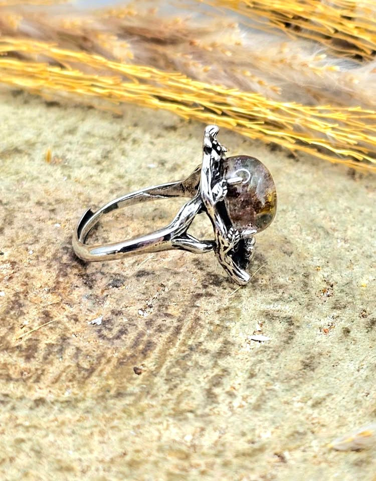 Garden quartz ring with high‑clarity crystal and green‑brown inclusions, floral wood‑branch band with butterfly, adjustable size, side view-My Aura Gemstones