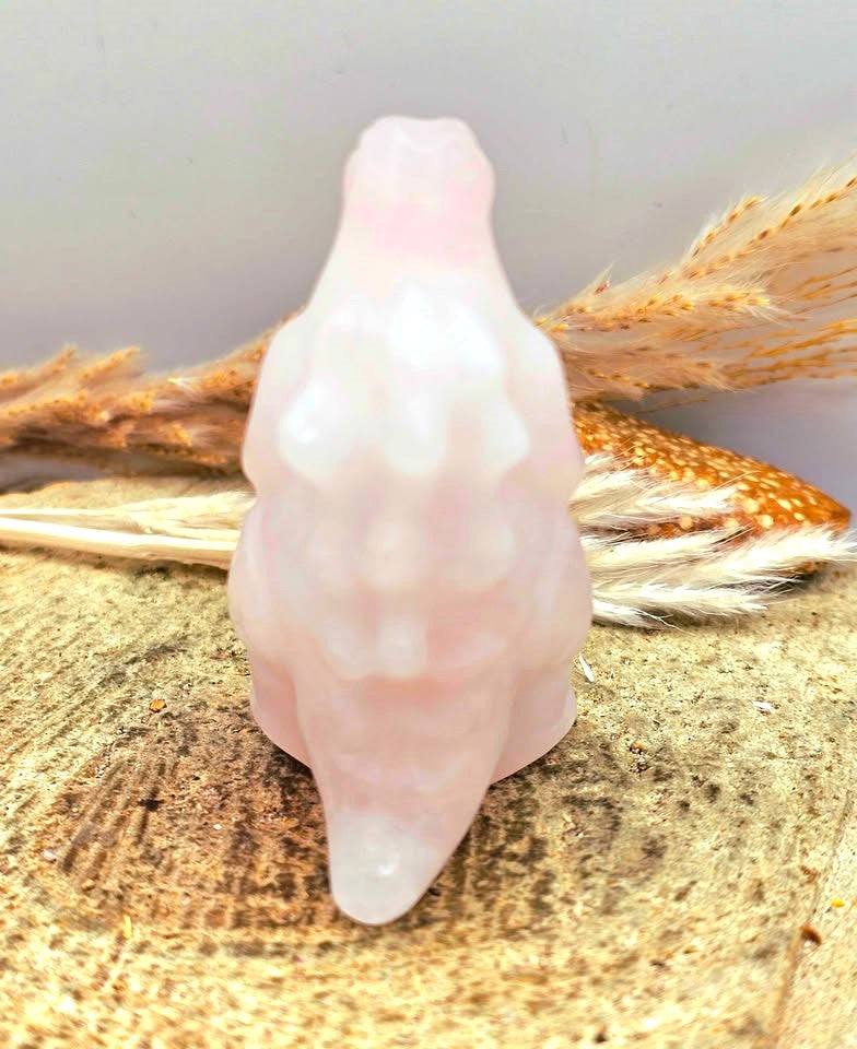 Rose quartz gorilla‑inspired figurine, light pink carving with detailed body, spine, and tail, 2.4" crystal sculpture, back view -My Aura Gemstones