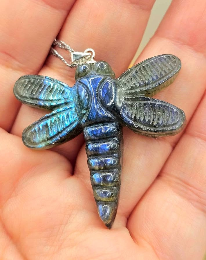 Natural labradorite craved  dragonfly-shaped pendant necklace with iridescent blue in front review on hand-My Aura Gemstones