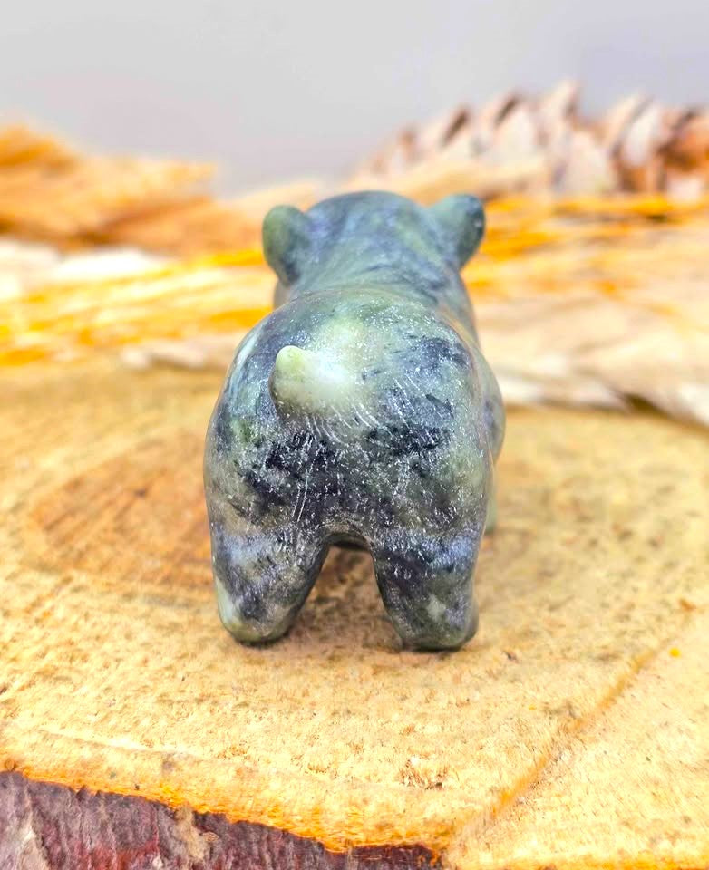 A small Serpentine carved stone figurine of a dog shown from behind-My Aura Gemstones