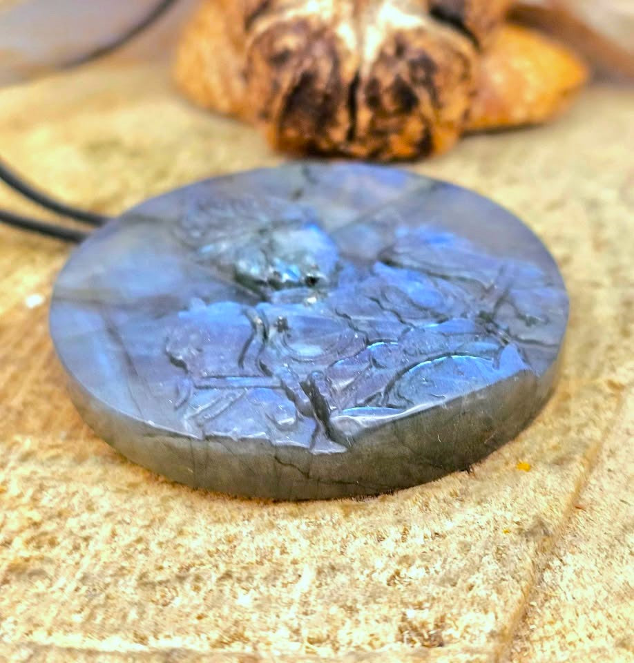 A labradorite carved round pendant necklace featuring a carved of powerful monkey king in bottom view on a wood slice-My Aura Gemstones