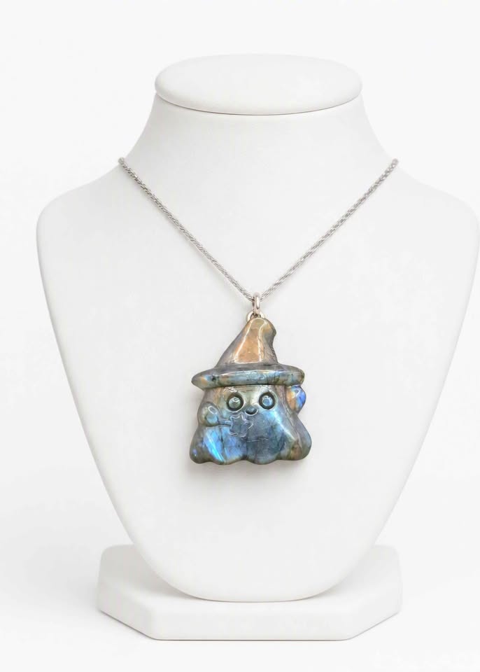 Natural labradorite carved ghost wizard-shaped pendant displays on jewelry stand- My Aura Gemstones.