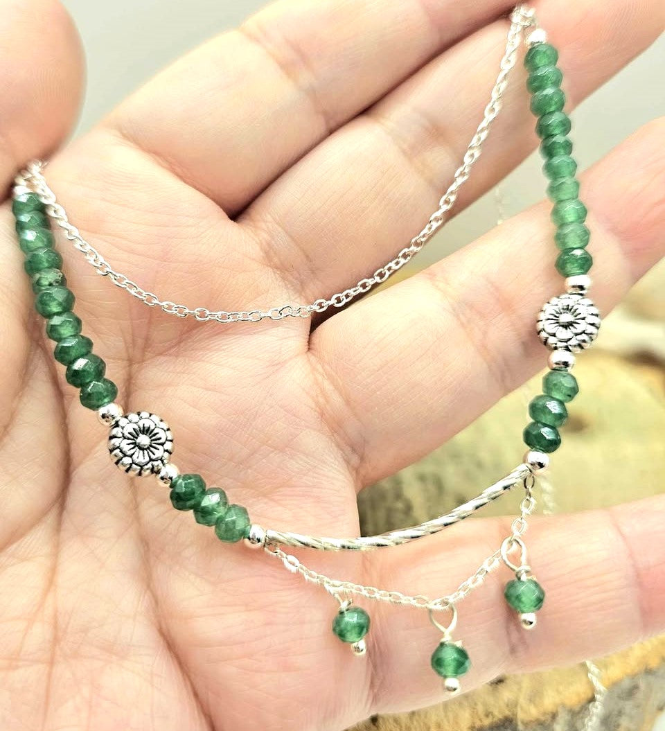“Handmade strawberry quartz necklace with faceted flashy beads and multi‑chain hanging drop design on silver accents