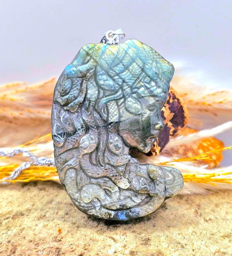 Natural Labradorite Medusa Side face carved with natural labradorite at front view, displays on wood slice-My Aura Gemstones