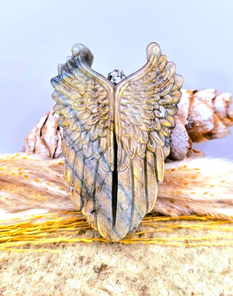 Natural Labradorite Flashy Angel Wing Pendant Necklace displays on wood slice-My Aura Gemstones