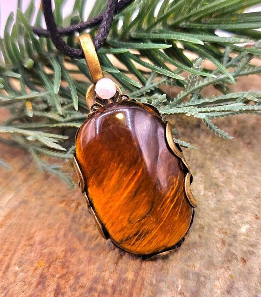 Tiger eye polished stone pendant with brass floral wrap — My Aura Gemstones