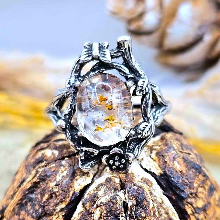 Garden quartz ring with high‑clarity crystal and green‑brown inclusions, floral wood‑branch band with butterfly, adjustable size-My Aura Gemstones